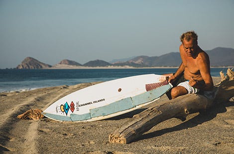 Tom Curren fixing a surfboard